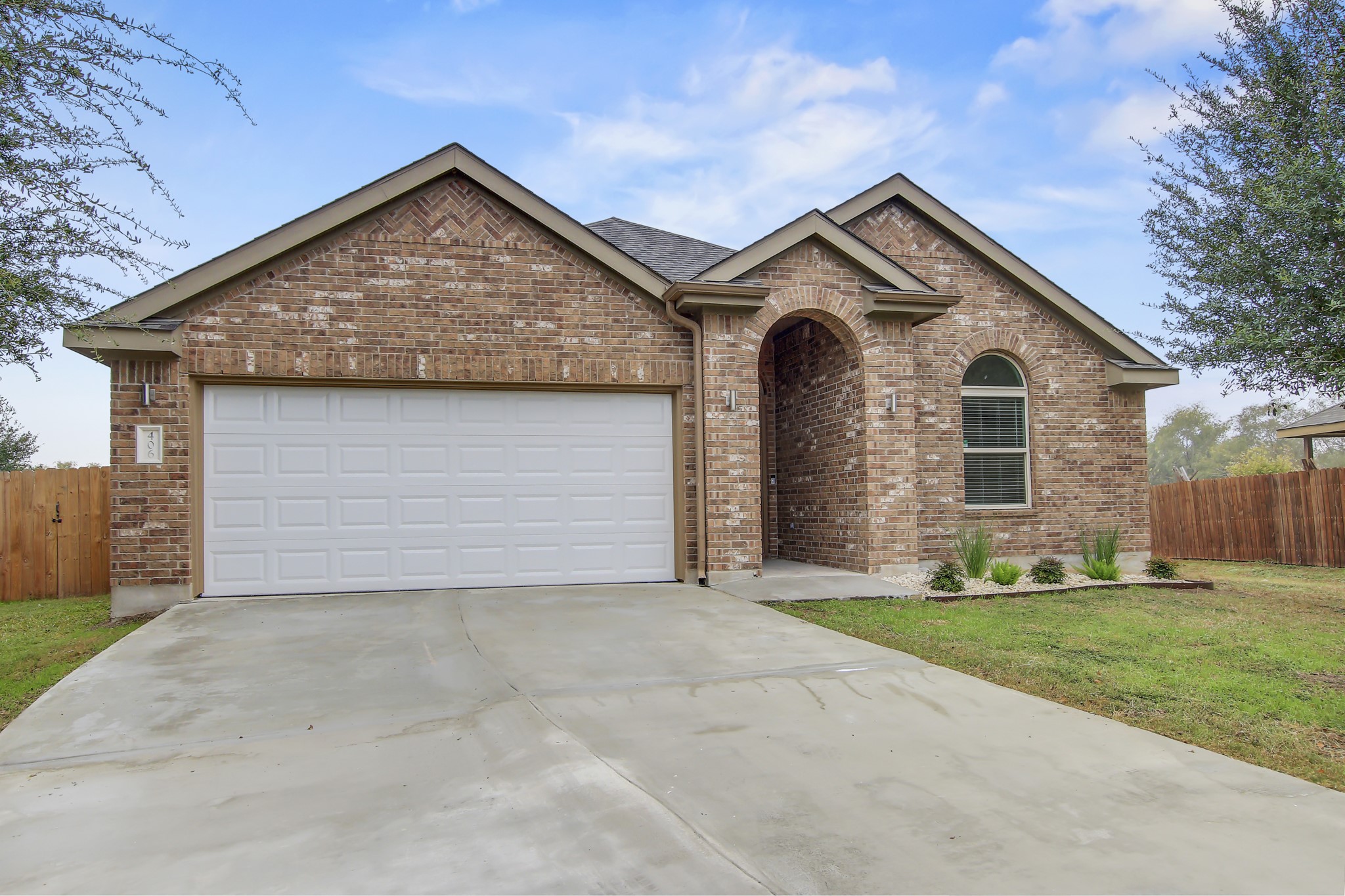 406 Dragon Ridge Road Buda, TX 78610 - Photo 1 of 1 Ranch-style home featuring brick siding, driveway, and a garage