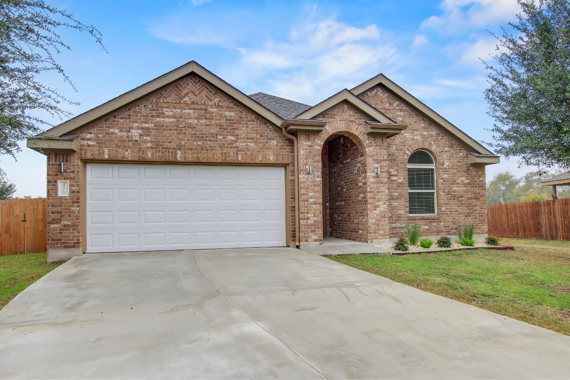 a view of a house with a yard and garage