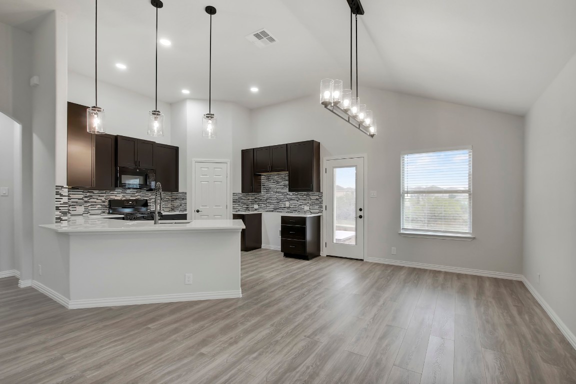 406 Dragon Ridge Road Buda, TX 78610 - Photo 12 of 39 a view of kitchen with sink microwave and wooden floor