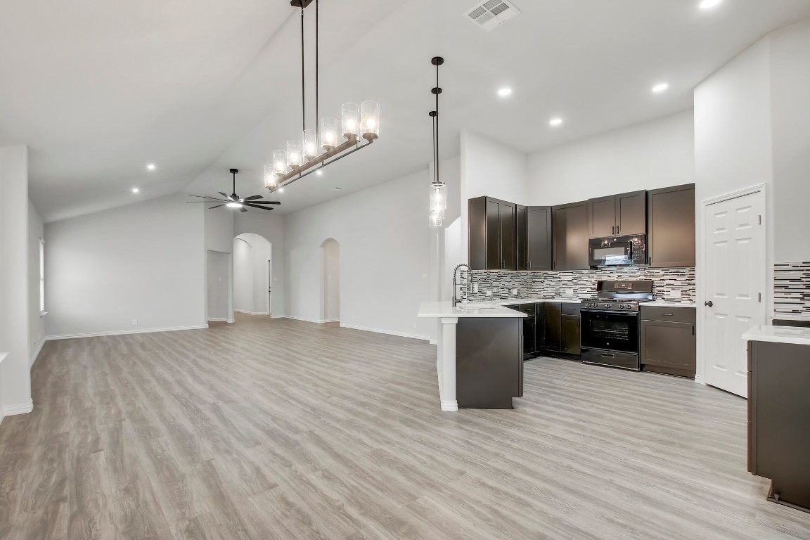 406 Dragon Ridge Road Buda, TX 78610 - Photo 17 of 39 a large kitchen with a lot of counter space and wooden floor