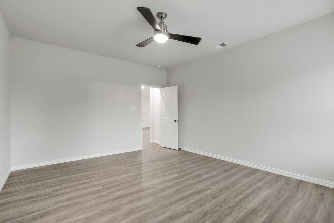 406 Dragon Ridge Road Buda, TX 78610 - Photo 20 of 39 a view of an empty room with wooden floor