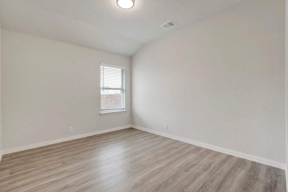 406 Dragon Ridge Road Buda, TX 78610 - Photo 25 of 39 an empty room with wooden floor and window