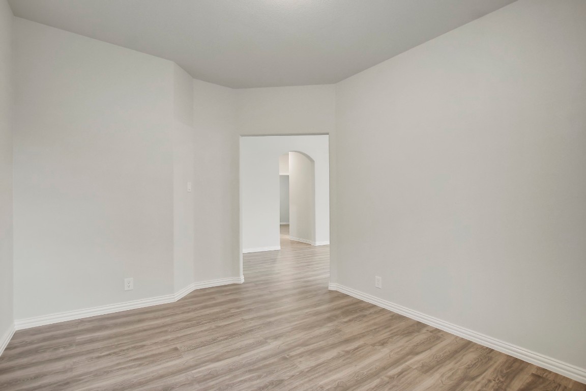 406 Dragon Ridge Road Buda, TX 78610 - Photo 26 of 39 a view of an empty room and wooden floor