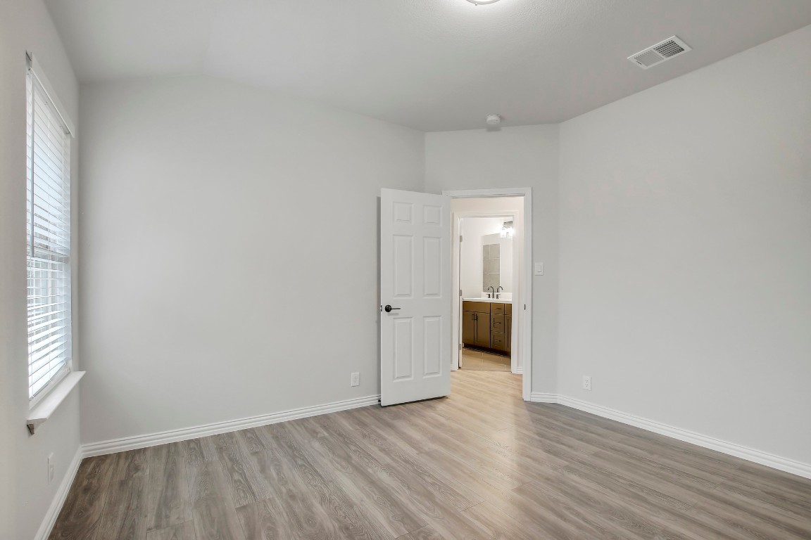 406 Dragon Ridge Road Buda, TX 78610 - Photo 32 of 39 a view of a room with wooden floor and a window