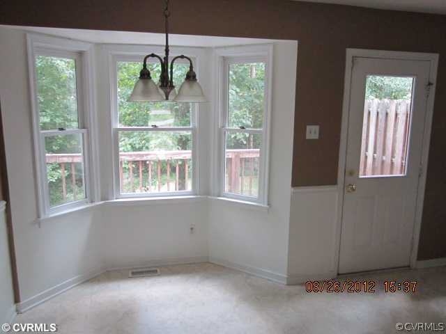 8617 Boones Trail Road Chesterfield, VA 23832 - Photo 5 of 10 a view of an empty room with windows and outdoor space