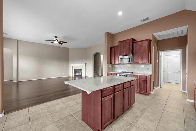 a kitchen with stainless steel appliances granite countertop a sink counter space and cabinets