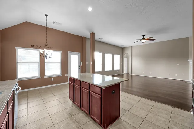 a kitchen with stainless steel appliances granite countertop a sink counter top space and a window