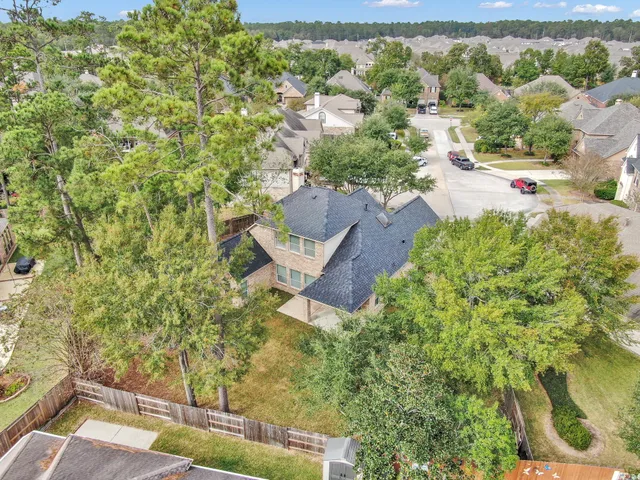 an aerial view of a house with a yard