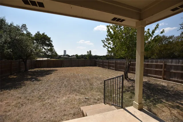 a view of balcony with wooden floor and fence