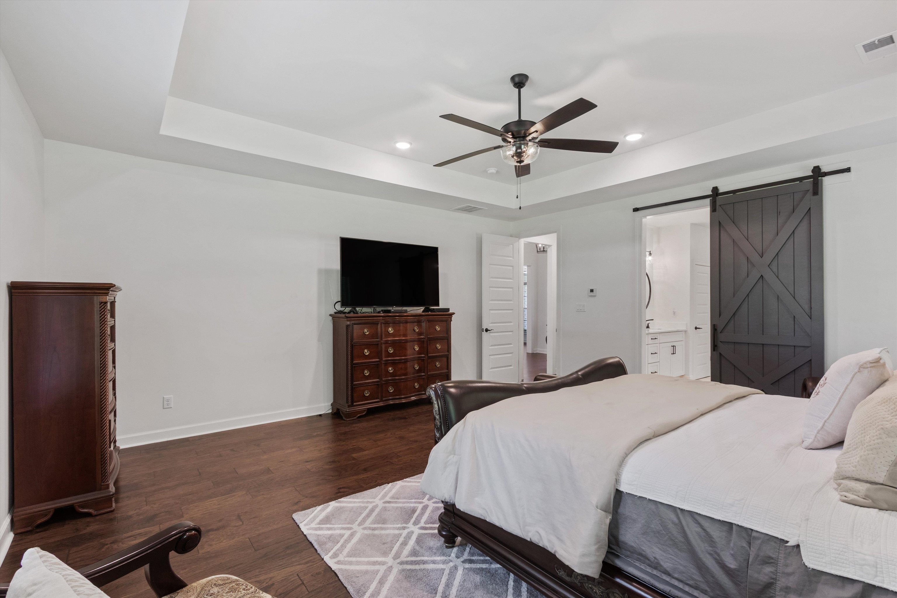 65 Watson Road Oakland, TN 38060 - Photo 17 of 40 a bedroom with a bed and a flat screen tv