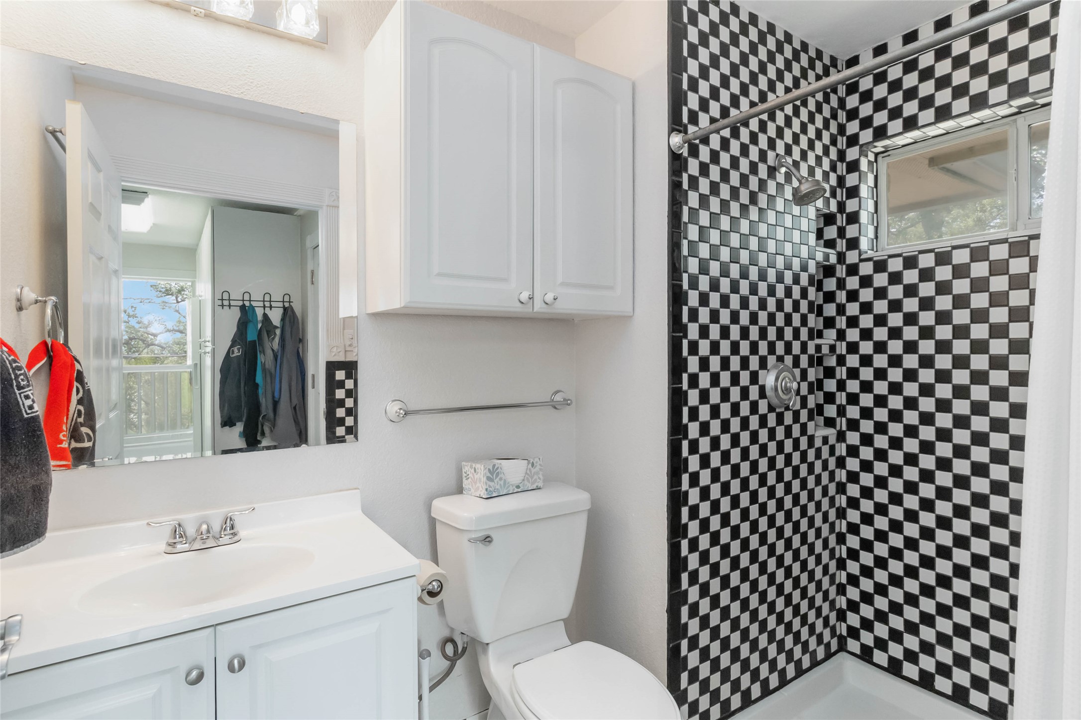1208 Jeddo Road Rosanky, TX 78953 - Photo 25 of 40 Bold checkerboard tiling creates a distinctive shower space within this compact bathroom.