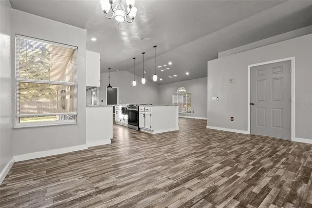 a view of a kitchen with marble kitchen and stainless steel appliances wooden floor