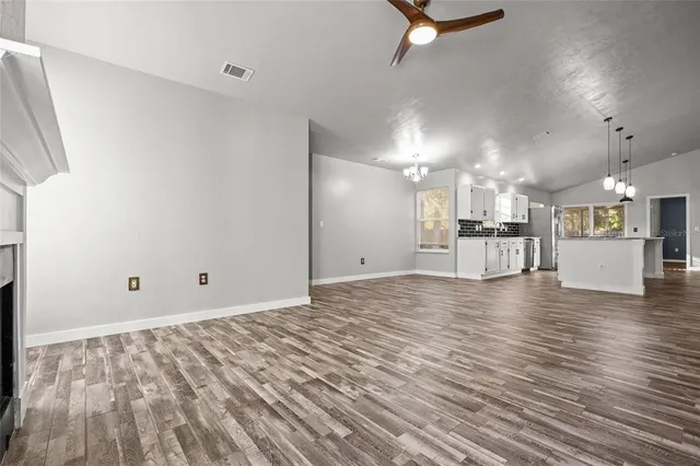 a view of a kitchen with a kitchen counter top and a wooden floor