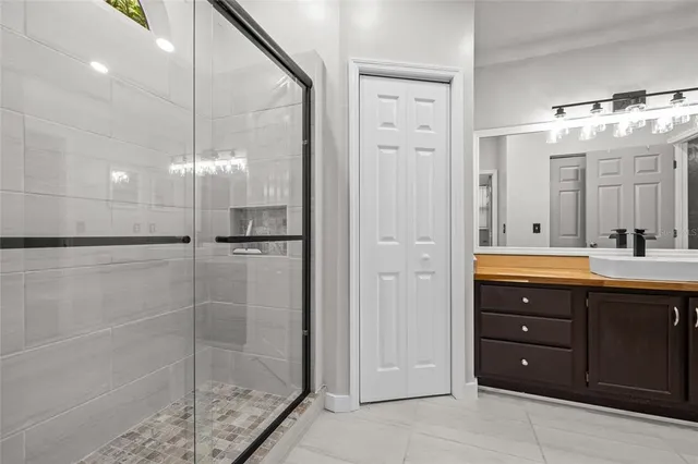 a bathroom with a shower vanity and a sink