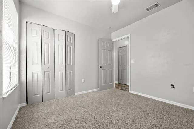 a view of an empty room with closet area