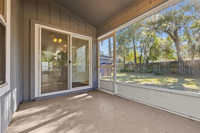 a view of a yard in front of a house with large tree