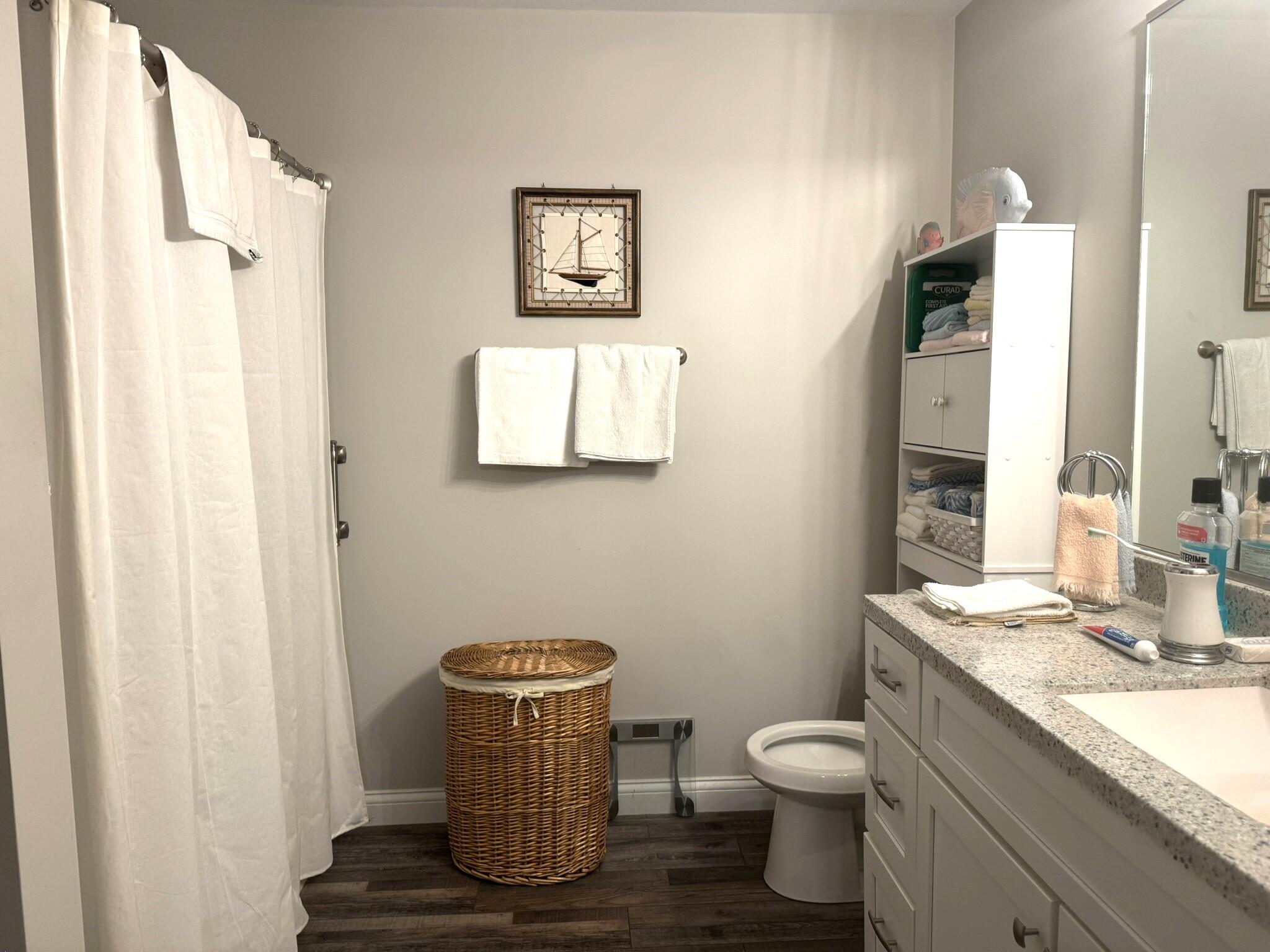 925 6th Avenue Northwest De Motte, IN 46310 - Photo 14 of 22 a bathroom with a granite countertop toilet a sink and a mirror