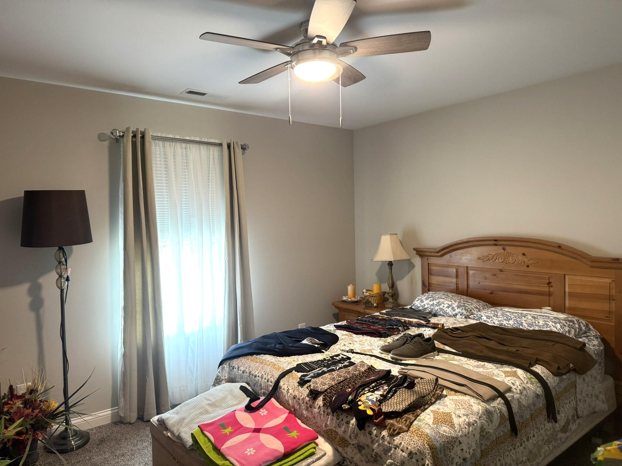 925 6th Avenue Northwest De Motte, IN 46310 - Photo 18 of 22 a bedroom with a bed and a chandelier