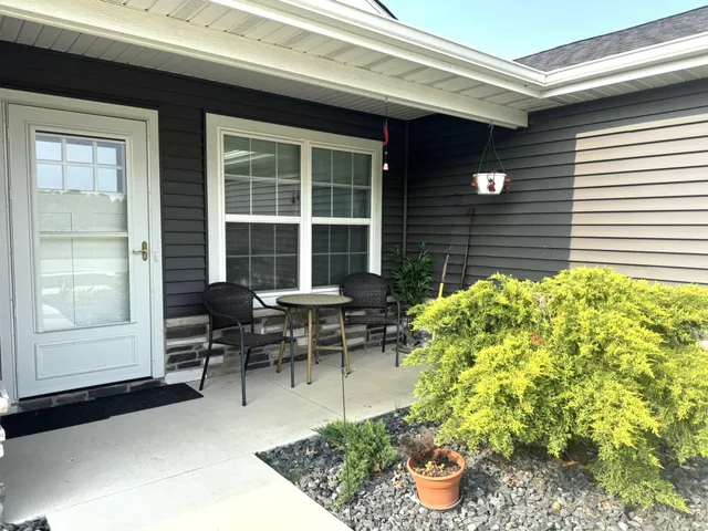 a living room filled with furniture and a potted plant