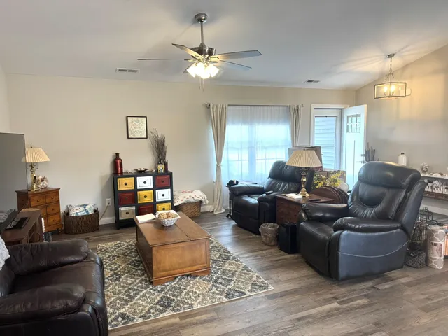 a kitchen with refrigerator cabinets dining table and chairs