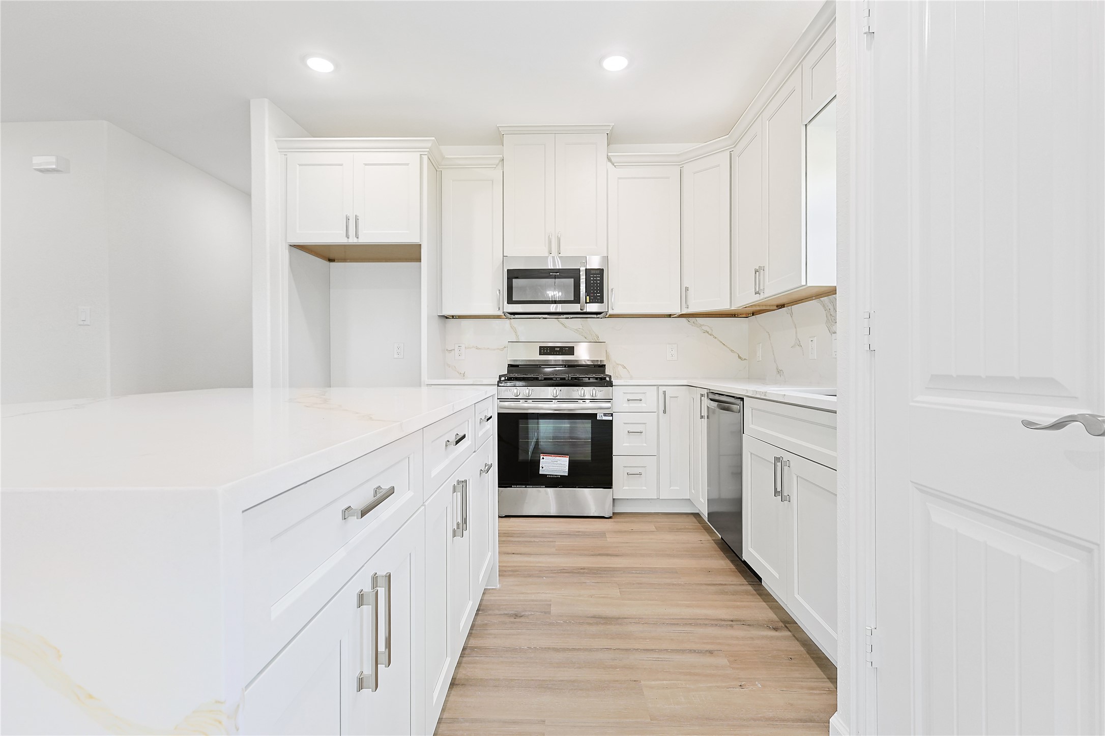 2317 Cedar Street Pearland, TX 77581 - Photo 12 of 33 a kitchen with white cabinets and appliances