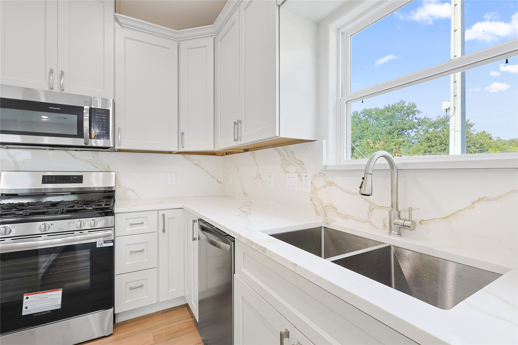 2317 Cedar Street Pearland, TX 77581 - Photo 15 of 33 a kitchen with a sink cabinets and stainless steel appliances