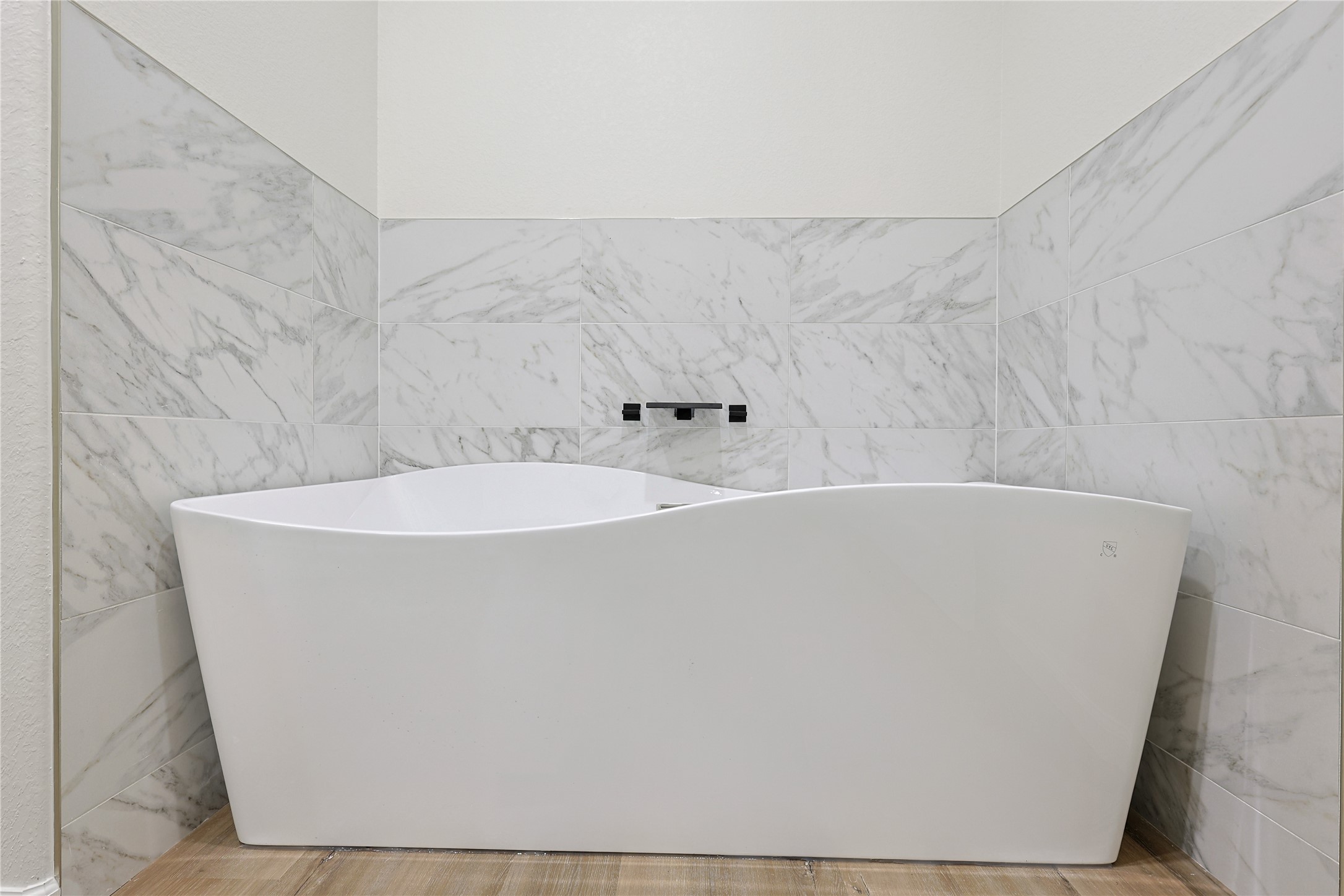 2317 Cedar Street Pearland, TX 77581 - Photo 22 of 33 a white bath tub sitting in a bathroom