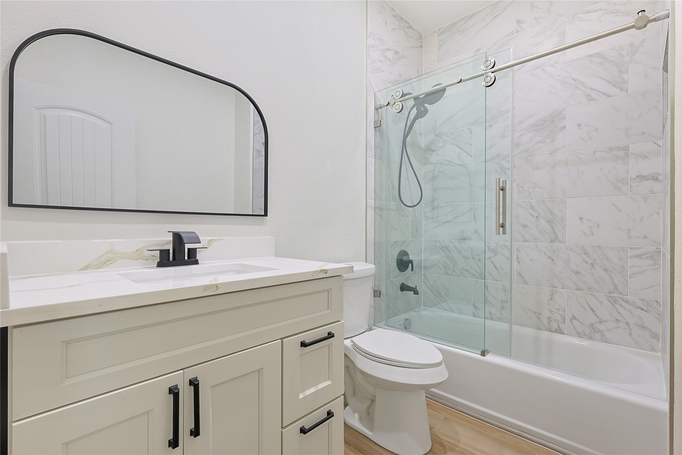 2317 Cedar Street Pearland, TX 77581 - Photo 26 of 33 a bathroom with a sink a toilet and a mirror