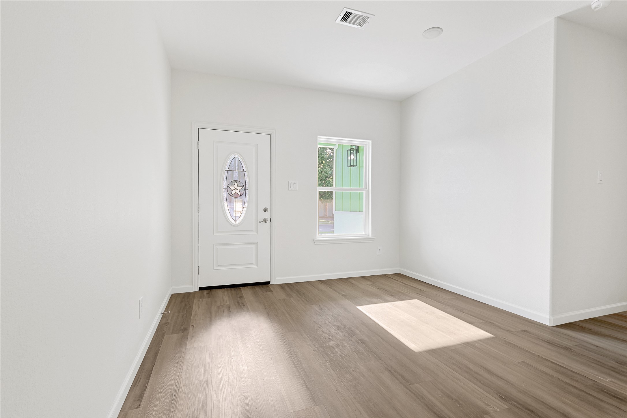 2317 Cedar Street Pearland, TX 77581 - Photo 5 of 33 an empty room with wooden floor and window