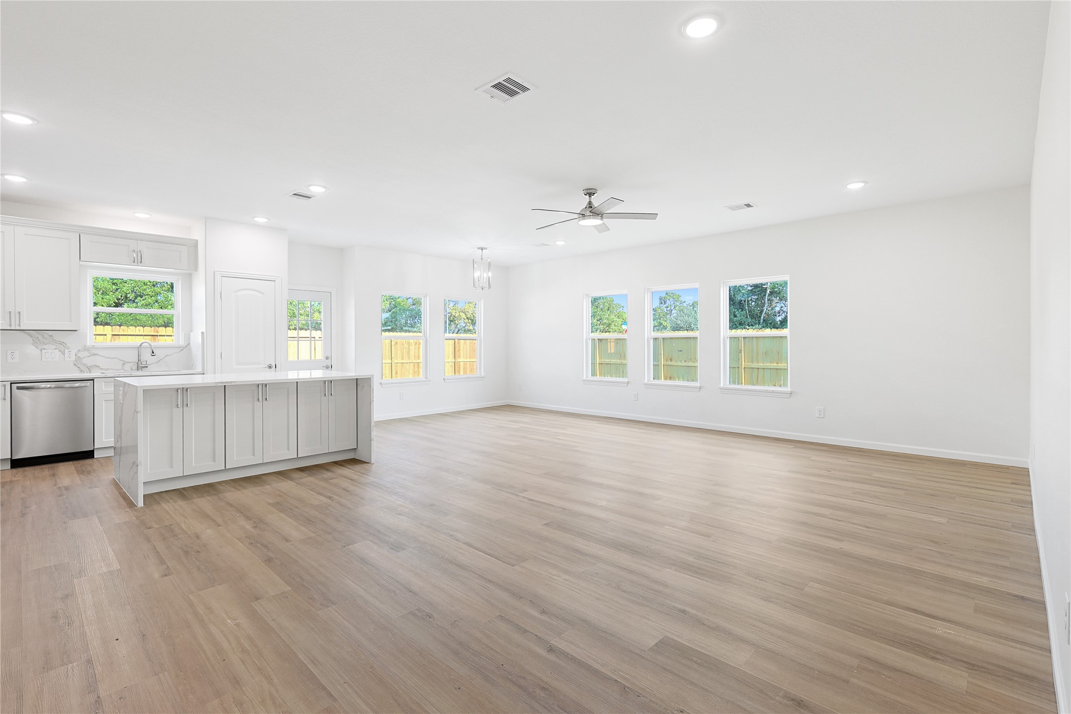 2317 Cedar Street Pearland, TX 77581 - Photo 10 of 33 a view of an empty room with a window and wooden floor