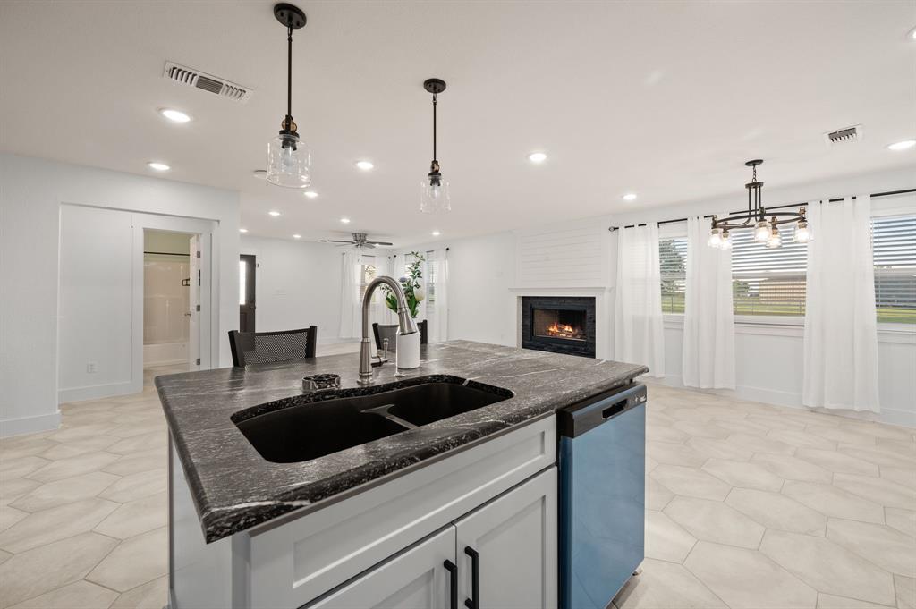 7384 Rector Road Sanger, TX 76266 - Photo 12 of 40 a kitchen with a sink and a refrigerator