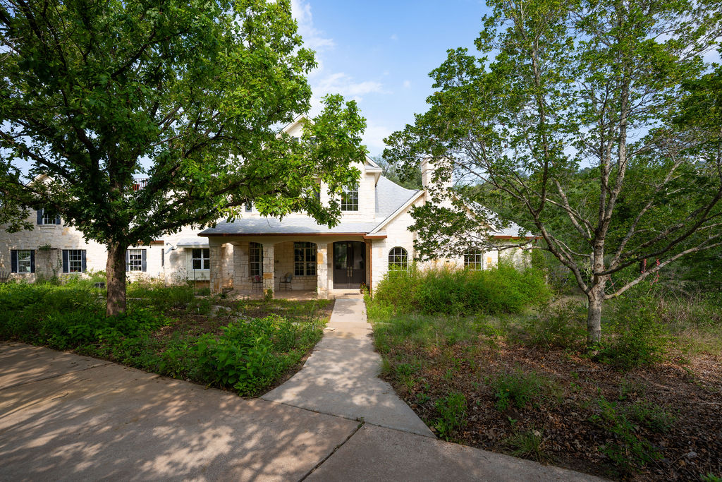 13800 Lone Rider Trail Austin, TX 78738 - Photo 2 of 27 a front view of a house with a yard