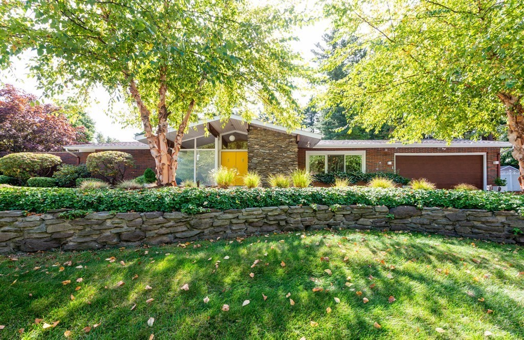 a front view of house with yard and green space