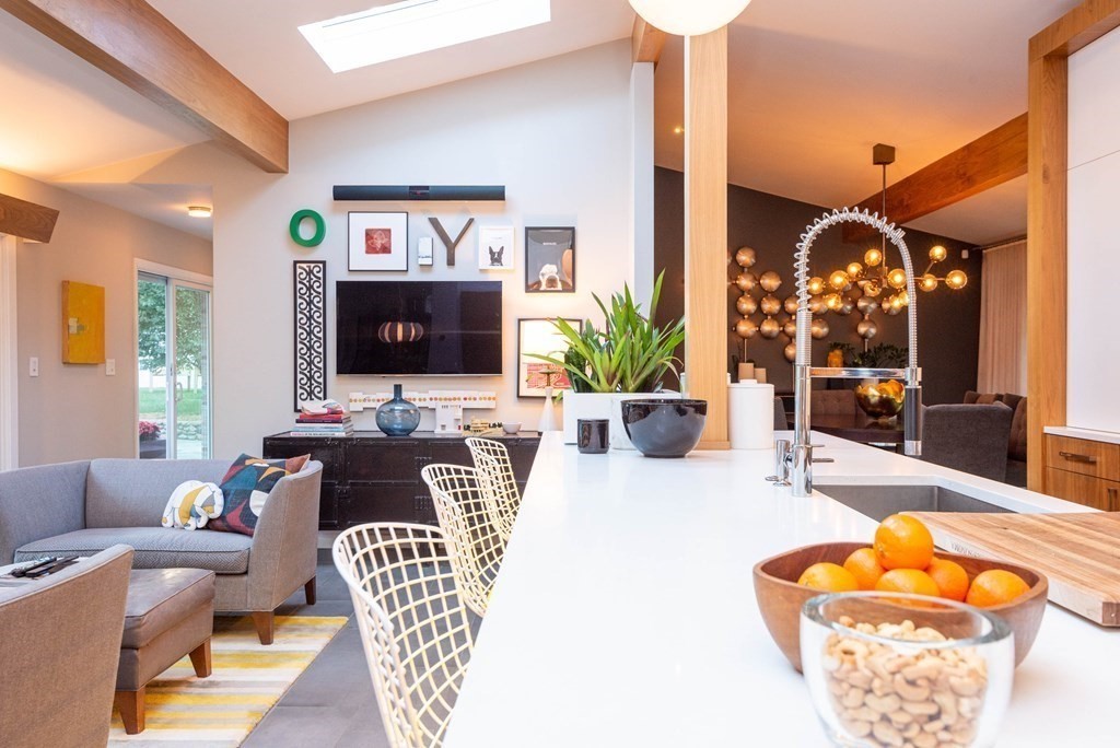 12 Alexandra Road Lynnfield, MA 01940 - Photo 11 of 42 a living room with furniture a fireplace and a potted plant