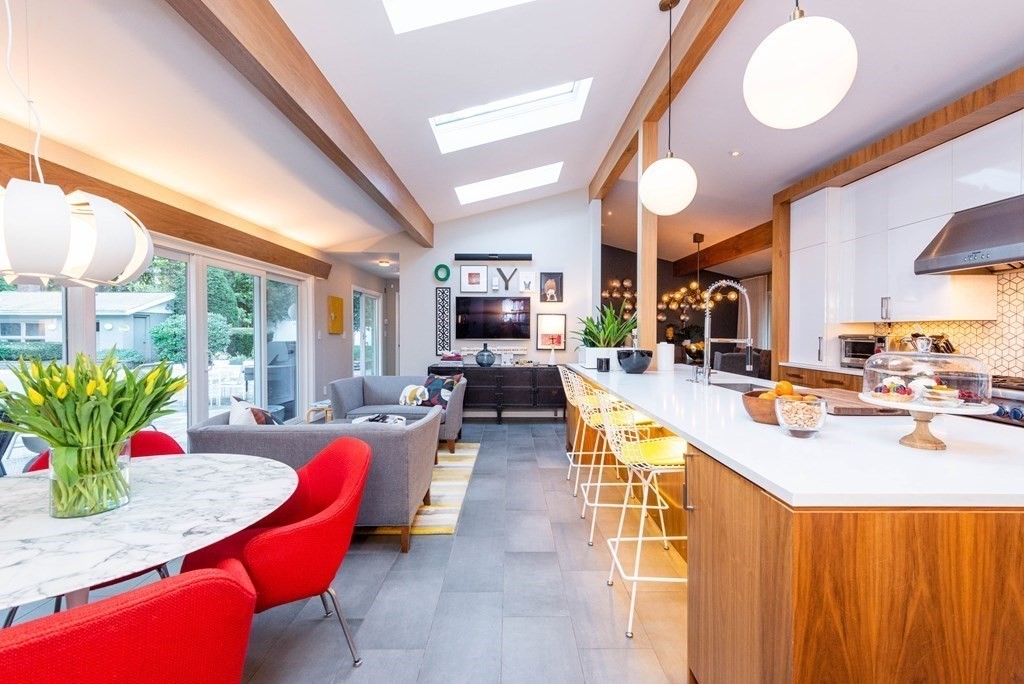 12 Alexandra Road Lynnfield, MA 01940 - Photo 12 of 42 a view of a dining room with furniture a chandelier and a large window