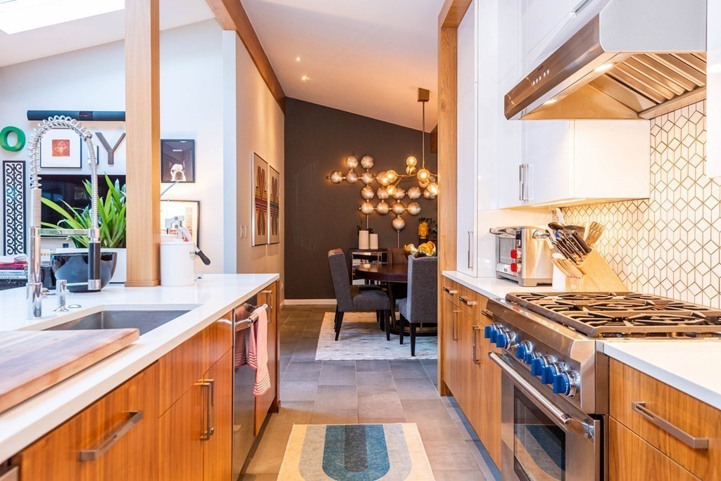 12 Alexandra Road Lynnfield, MA 01940 - Photo 18 of 42 a kitchen with stainless steel appliances granite countertop a stove and a wooden cabinets