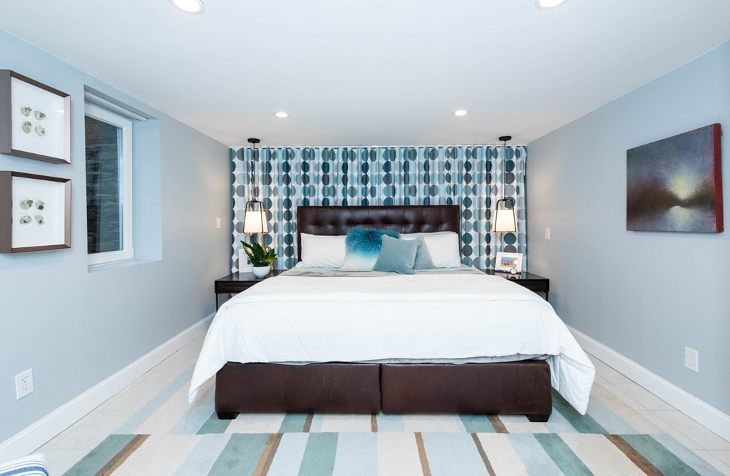 12 Alexandra Road Lynnfield, MA 01940 - Photo 29 of 42 a bed sitting in a bedroom next to a window