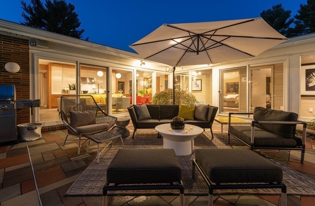 12 Alexandra Road Lynnfield, MA 01940 - Photo 37 of 42 a view of a patio with chairs and table under an umbrella