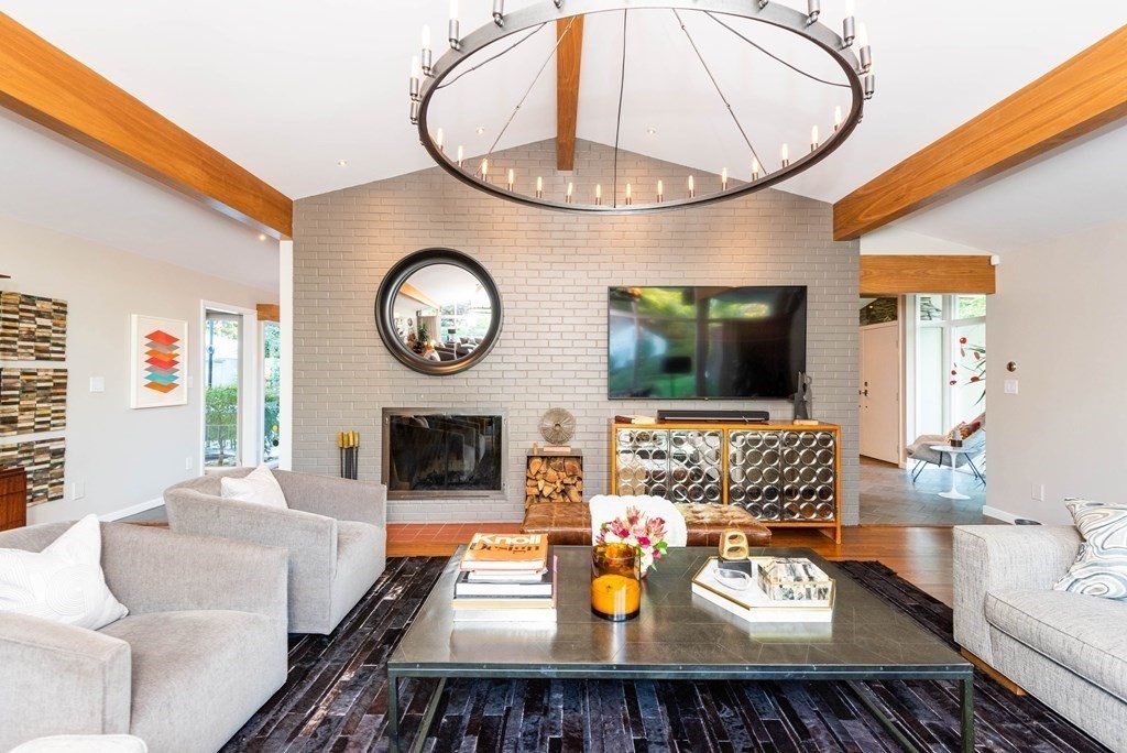 12 Alexandra Road Lynnfield, MA 01940 - Photo 7 of 42 a living room with furniture a clock and a flat screen tv