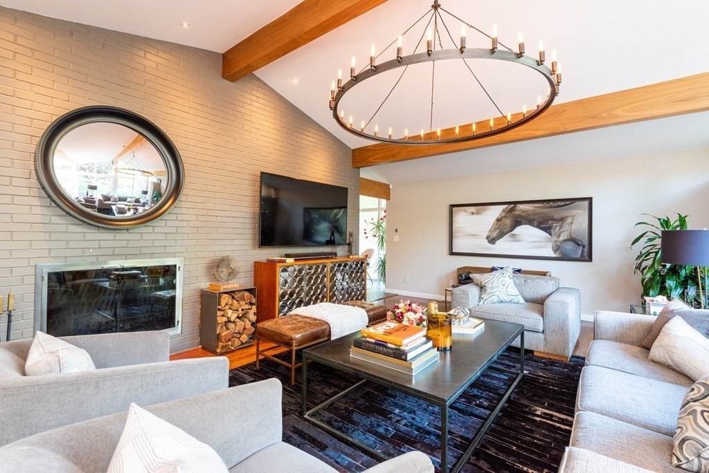 12 Alexandra Road Lynnfield, MA 01940 - Photo 8 of 42 a living room with furniture a flat screen tv and a wall clock