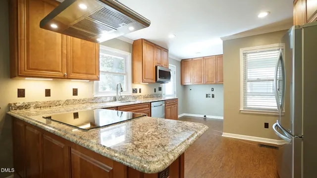a kitchen with a stove a sink and a refrigerator