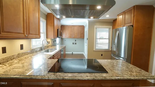 a kitchen with stainless steel appliances granite countertop a sink and a window