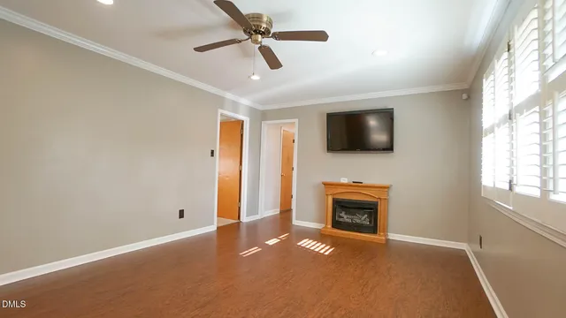 a view of an empty room with a fireplace and a window