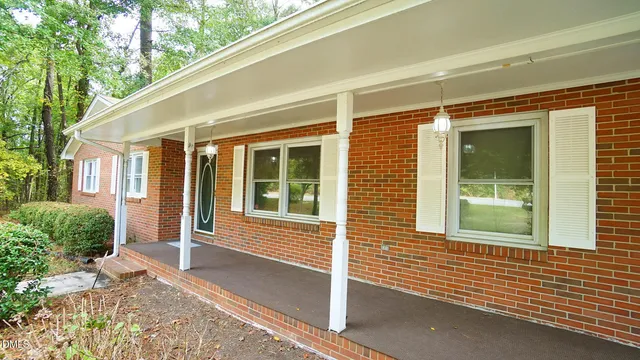 a view of house with a window and sitting area