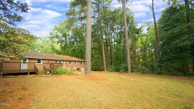 a view of backyard with a garden and trees