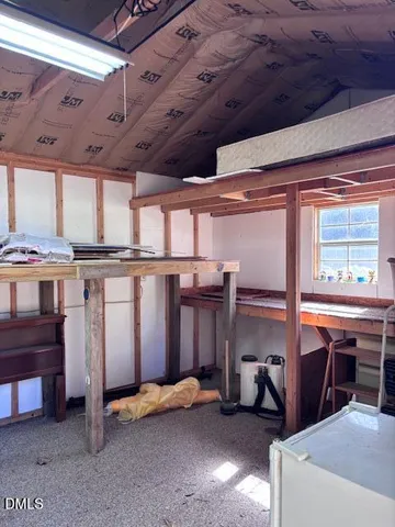a view of a livingroom with furniture and a window