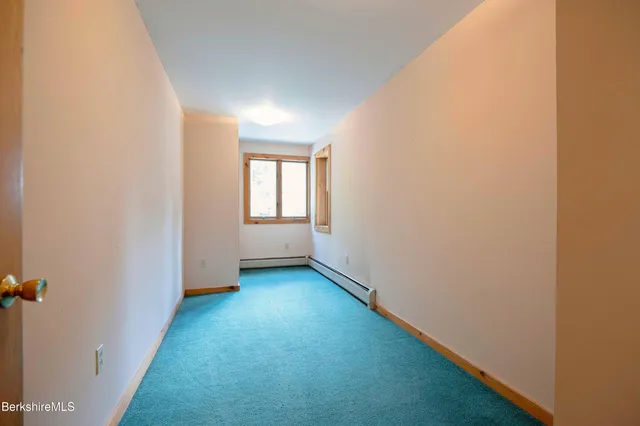 a view of staircase with white walls and a window