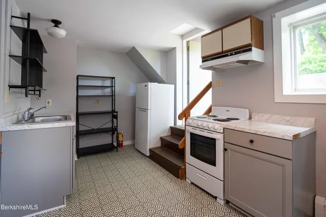 a view of a room with wooden floor and a window