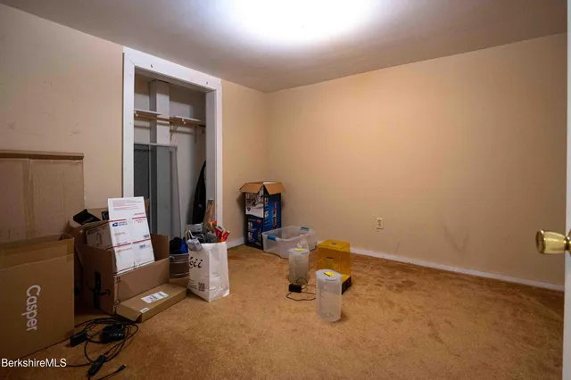 a living room with furniture a flat screen tv and a rug