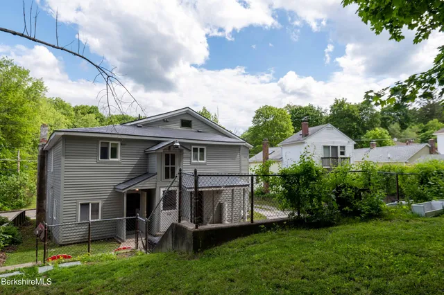a front view of house with yard and green space